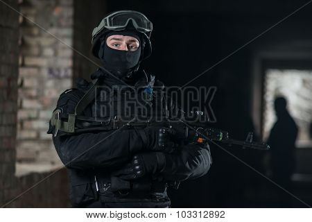 Fully equipped military men with automatic weapons playing airsoft strikeball