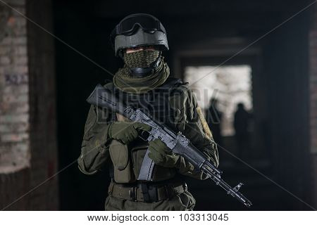 Fully equipped military men with automatic weapons playing airsoft strikeball