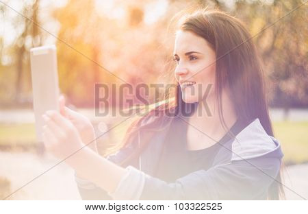 Beautiful Girl With Tablet Or Ebook Outdoor