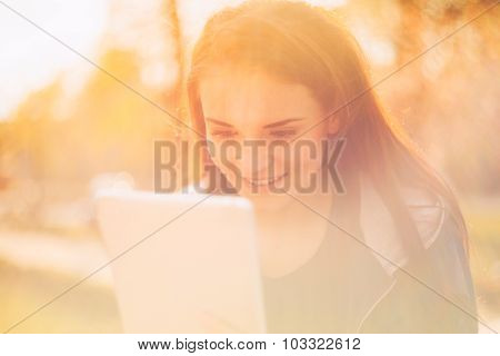 Beautiful Girl With Tablet Or Ebook Outdoor