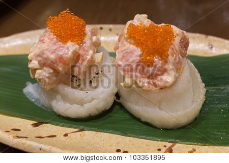 Engawa roll with salmon salad on top
