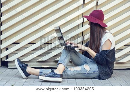 young woman using laptop outddor