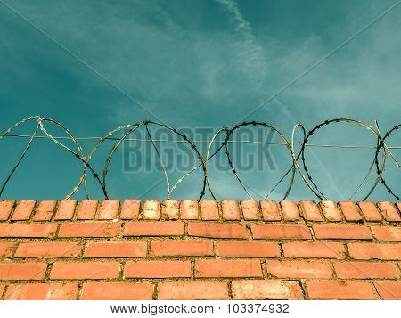Barbed Wire On A Brick Wall