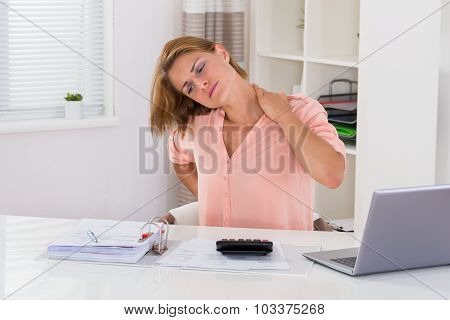 Woman Having Neckache At Desk