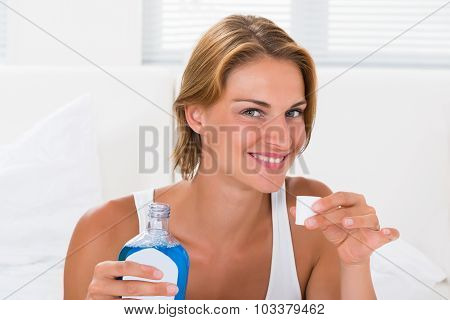 Woman Holding Bottle Of Mouthwash