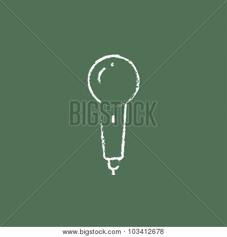 Microphone hand drawn in chalk on a blackboard vector white icon isolated on a green background.