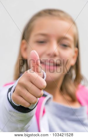 Little child girl happy face showing thumbs up