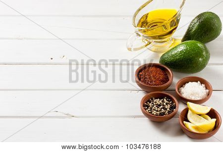 Avocado, and other ingredients for sauce guacamole on the table.