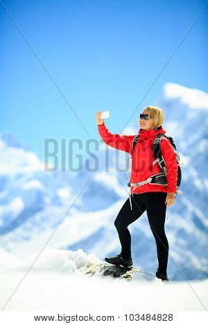 Woman Doing Smartphone Selfie In Mountains