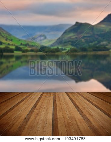 Llyn Nantlle At Sunrise Looking Towards Mist Shrouded Mount Snowdon With Wooden Planks Floor