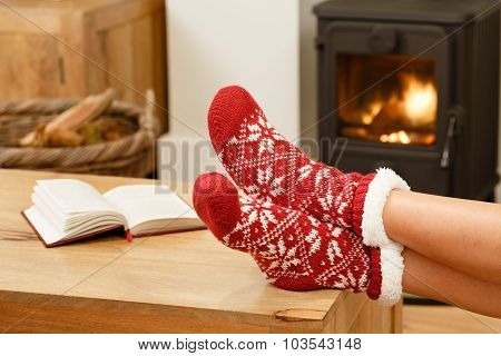 Woman Relaxing In Front Of Fire