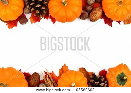 Autumn double border of pumpkins, leaves and nuts over white