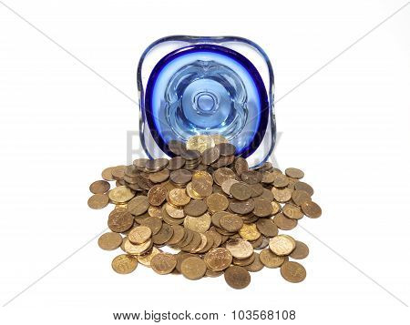 An overturned vase of small coins