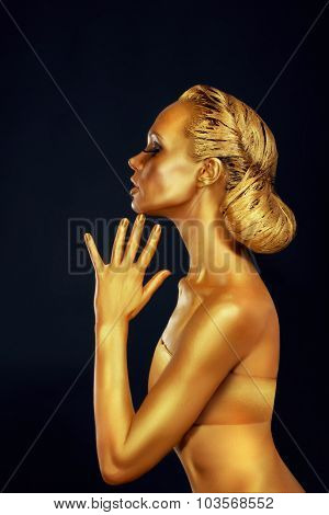 Woman With Golden Body Over Black Background