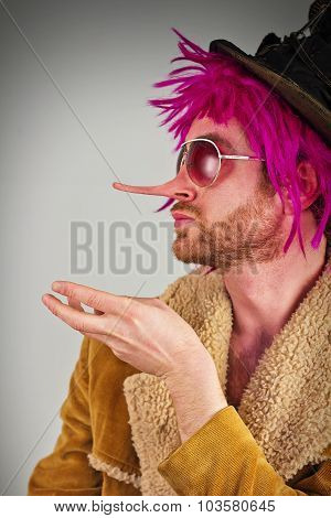 Lying pink haired bearded bum lunatic man with cool sunglasses