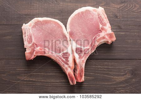 Top View Raw Pork Chop Steak On Wooden Background