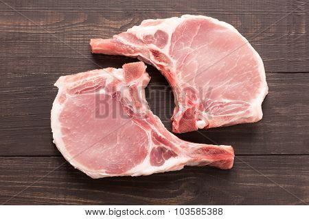 Top View Raw Pork Chop Steak On Wooden Background