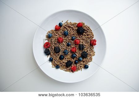 Muesli With Berries In White Dish On Blank White Table Top View