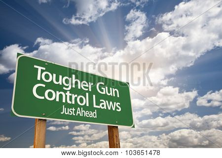 Tougher Gun Control Laws Green Road Sign With Dramatic Clouds and Sky.