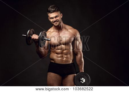 Muscular Bodybuilder Guy Doing Exercises With Dumbbells