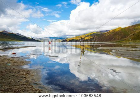 Traveler in Yamdrok lake in Tibet