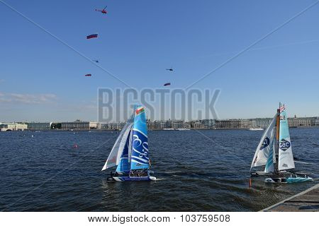 ST. PETERSBURG, RUSSIA - AUGUST 22, 2015: Helicopters with Russian flags over Extreme 40 catamarans during St. Petersburg stage of Extreme Sailing Series. The Day of Flag is celebrated in Russia today