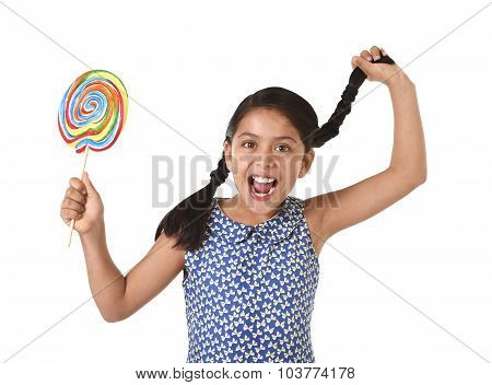 Happy Female Child Holding Big Lollipop Candy Pulling Pony Tail With Crazy Funny Face Expression In