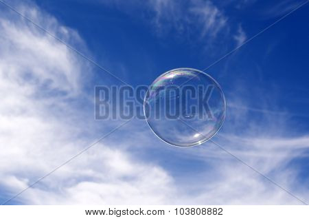Soap bubble fly in mid-air in sunny day against blue sky with white clouds. concept photo of freedom and happiness