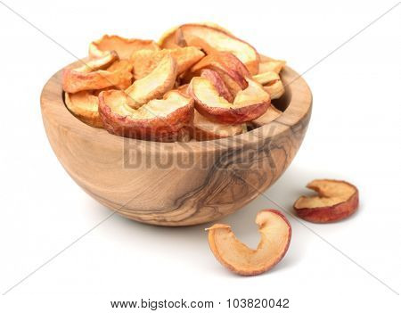 Dried apple slices in woodenl bowl isolated on white