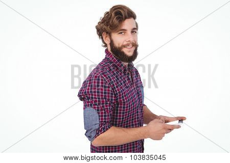 Portrait of confident hipster using smartphone against white backhround