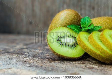 Close Up Fresh Kiwi Fruit On Old Wood Background.