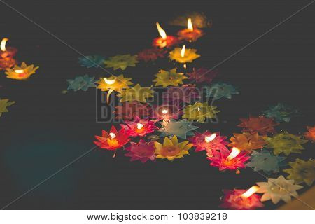 Flower-shaped Candle Burning In The Pool Of Spirit At Chinese Temple