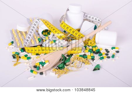 Pills and measuring tape isolated, wood spoone, concept diet