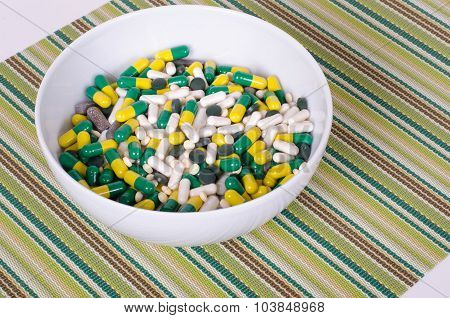 Plate of pills on striped cloth isolated, concept diet