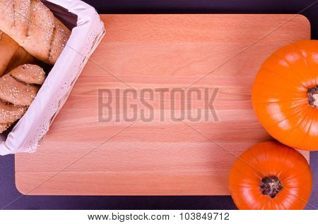 Fresh bread and pumpkin in a rustic style. Text