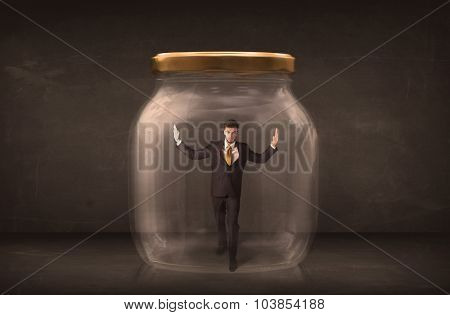 Businessman shut into a glass jar concept on background