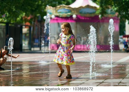 Two Sisters Playing With Fountain Splash