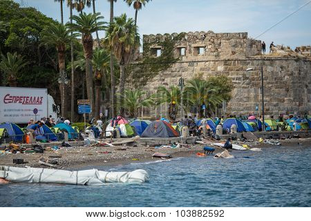 KOS, GREECE - SEP 28, 2015: Tents war refugees in the port of Kos island. Kos island is located just 4 kilometers from the Turkish coast, and many refugees come from Turkey in an inflatable boats.