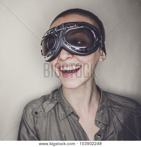 girl in retro pilot glasses with wooden plane
