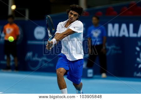 KUALA LUMPUR, MALAYSIA - SEPTEMBER 26, 2015: Syed Mohd Agil of Malaysia plays in his qualifying match in the Malaysian Open 2015 Tennis tournament held at the Putra Stadium, Malaysia.