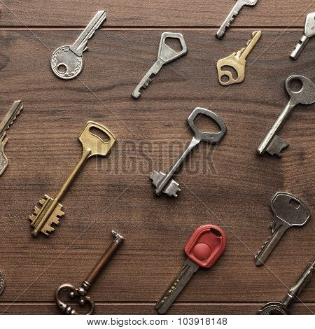 many different keys on wooden table