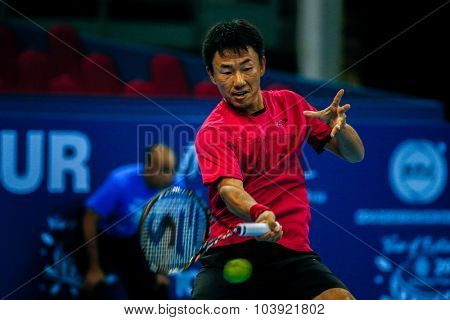 KUALA LUMPUR, MALAYSIA - SEPTEMBER 27, 2015: Takao Suzuki of Japan plays a return in his qualifying match at the Malaysian Open 2015 Tennis tournament held at the Putra Stadium, Malaysia.