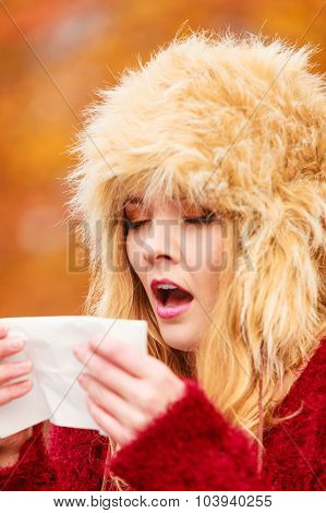 Sick Woman In Autumn Park Sneezing Into Tissue.
