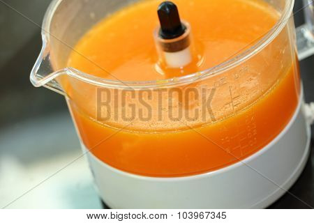 Fresh Orange Juice In Juicer Machine With Hand