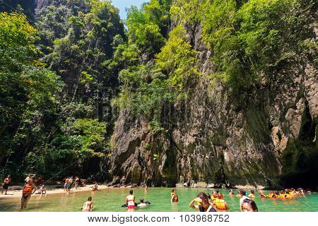KO LANTA, THAILAND, FEBRUARY 09, 2015 : Some tourists are bathing in the natural sea pool of the Emerald cave near the Ko Lanta island in Thailand