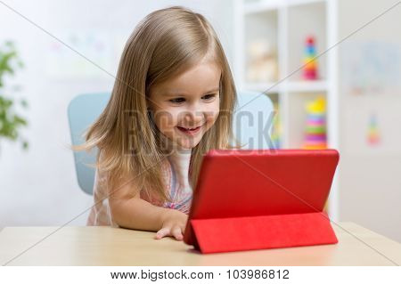 happy child little girl using tablet computer