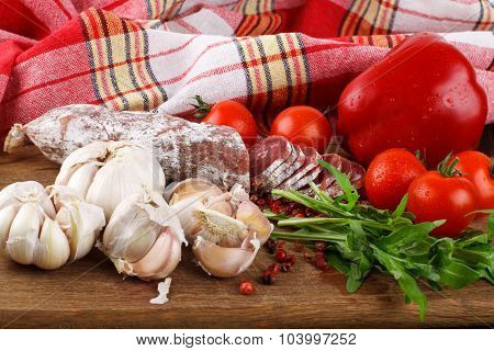 Salami On Cutting Board On Wooden Table
