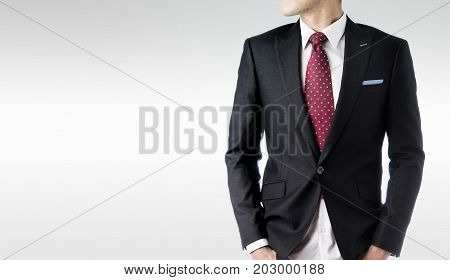 Business concept - confident modern business man with dark suit stand and think the business plan isolated on grey background.
