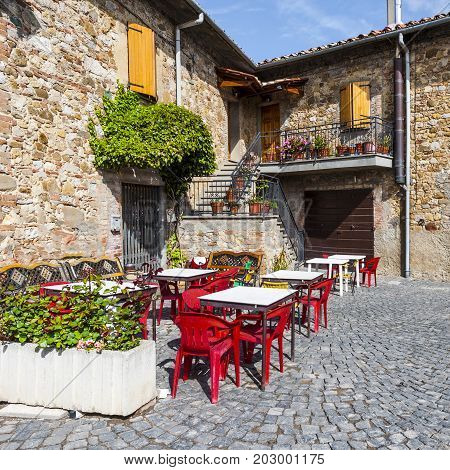 Village Trevinano located upon a hill near the borders of Lazio with the Tuscany and Umbria. Street cafe in a old city without people and cars in Italy. Narrow street in the medieval italian town.