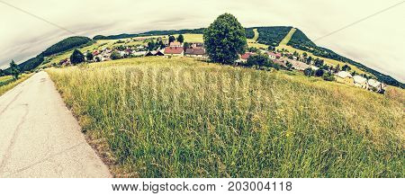 Panoramic photo of Cicmany village Slovak republic. Folklore theme. Rural landscape. Travel destination. Retro photo filter.